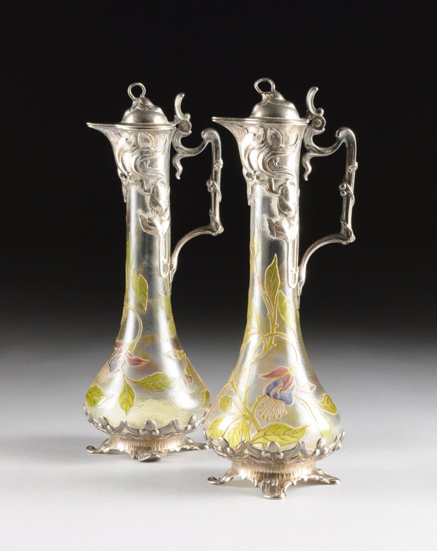 A PAIR OF WURTTEMBERGISCHE METTALWARENFABRIK (WMF) ACID: A PAIR OF WURTTEMBERGISCHE METTALWARENFABRIK (WMF) ACID ETCHED CAMEO GLASS SILVER PLATE MOUNTED CLARET JUGS, GEISLINGEN, GERMANY, CIRCA 1900, each of baluster form with fuchsia bud and flower cameo de