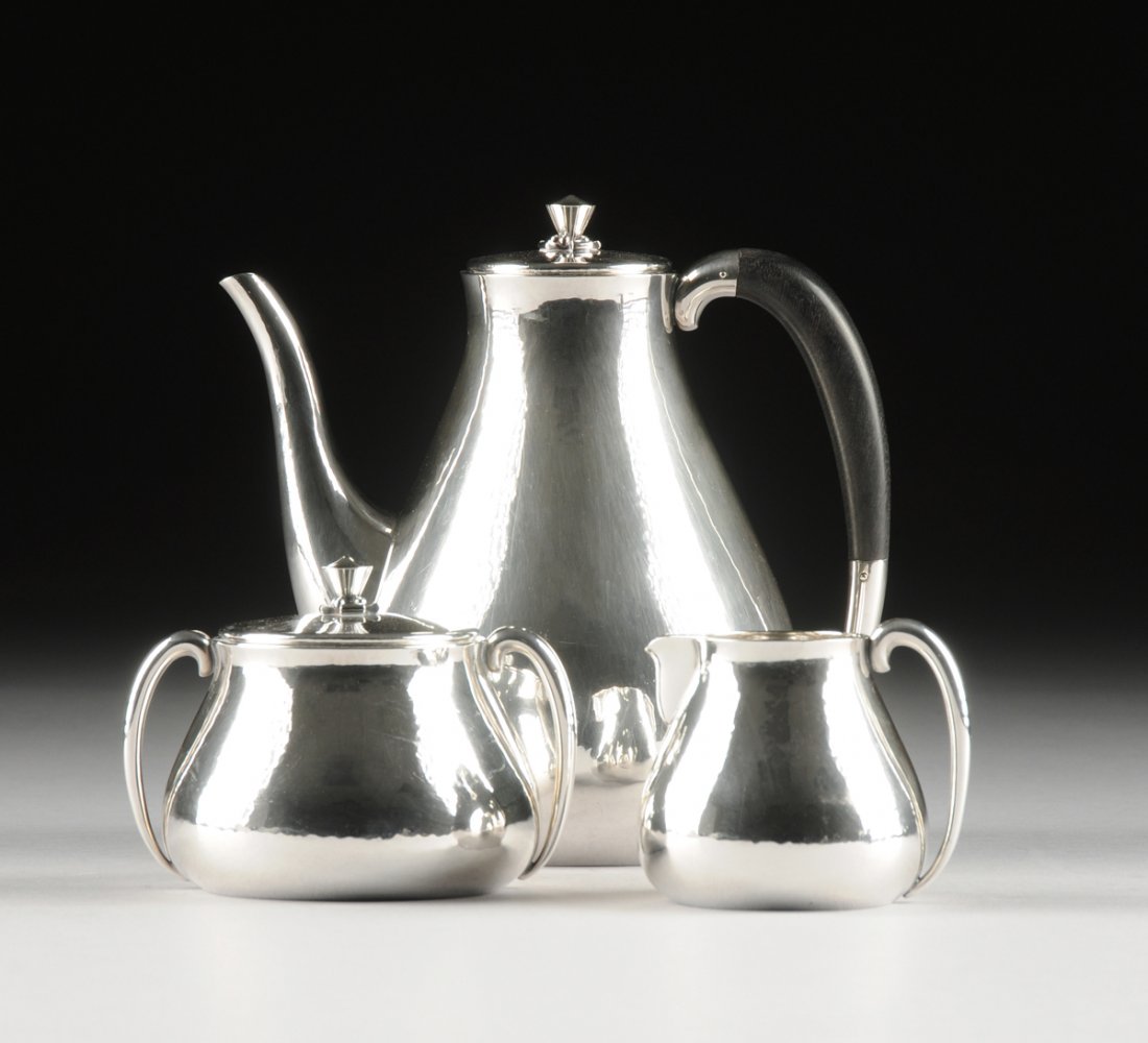 KARL GUSTAV HANSEN (Danish 1925-1994) A THREE PIECE: KARL GUSTAV HANSEN (Danish 1925-1994) A THREE PIECE STERLING SILVER AND EBONY COFFEE SERVICE, FOR HANS HANSEN, COPENHAGEN, DENMARK, 1958-1959, of elongated pear-shape, the coffee pot with "C" scroll e
