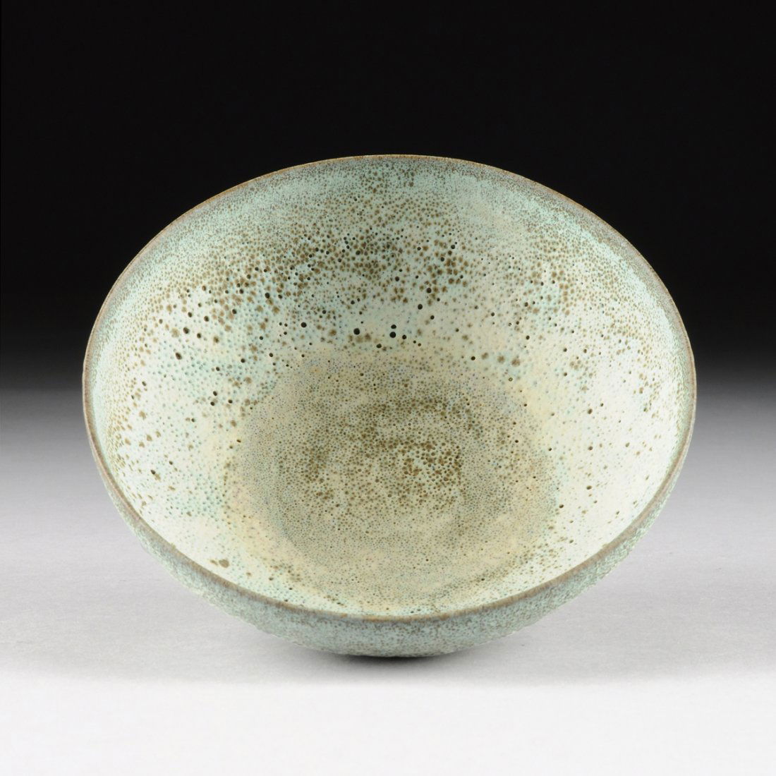 GERTRUD AND OTTO NATZLER (American 1908-1971/1908-2007): GERTRUD AND OTTO NATZLER (American 1908-1971/1908-2007) AN EARTHENWARE BOWL WITH PALE GREEN AND BROWN CRATER GLAZE, LOS ANGELES, CALIFORNIA, CIRCA 1955, of low form with large glaze drop to the base a