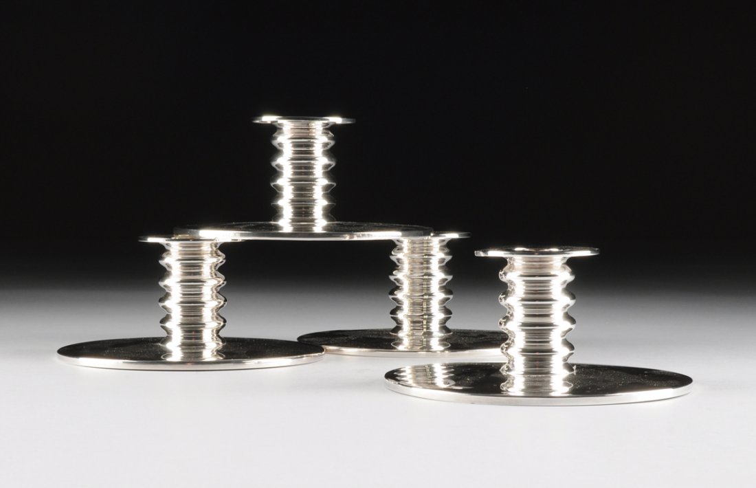 KAY OTTO FISKER (Danish 1893-1965) A SET OF FOUR: KAY OTTO FISKER (Danish 1893-1965) A SET OF FOUR STERLING SILVER CANDLE HOLDERS, FOR A. MICHELSEN, COPENHAGEN, DENMARK, DESIGNED 1935, PRODUCED 1963, with knopped stems supporting disk form drip pan o