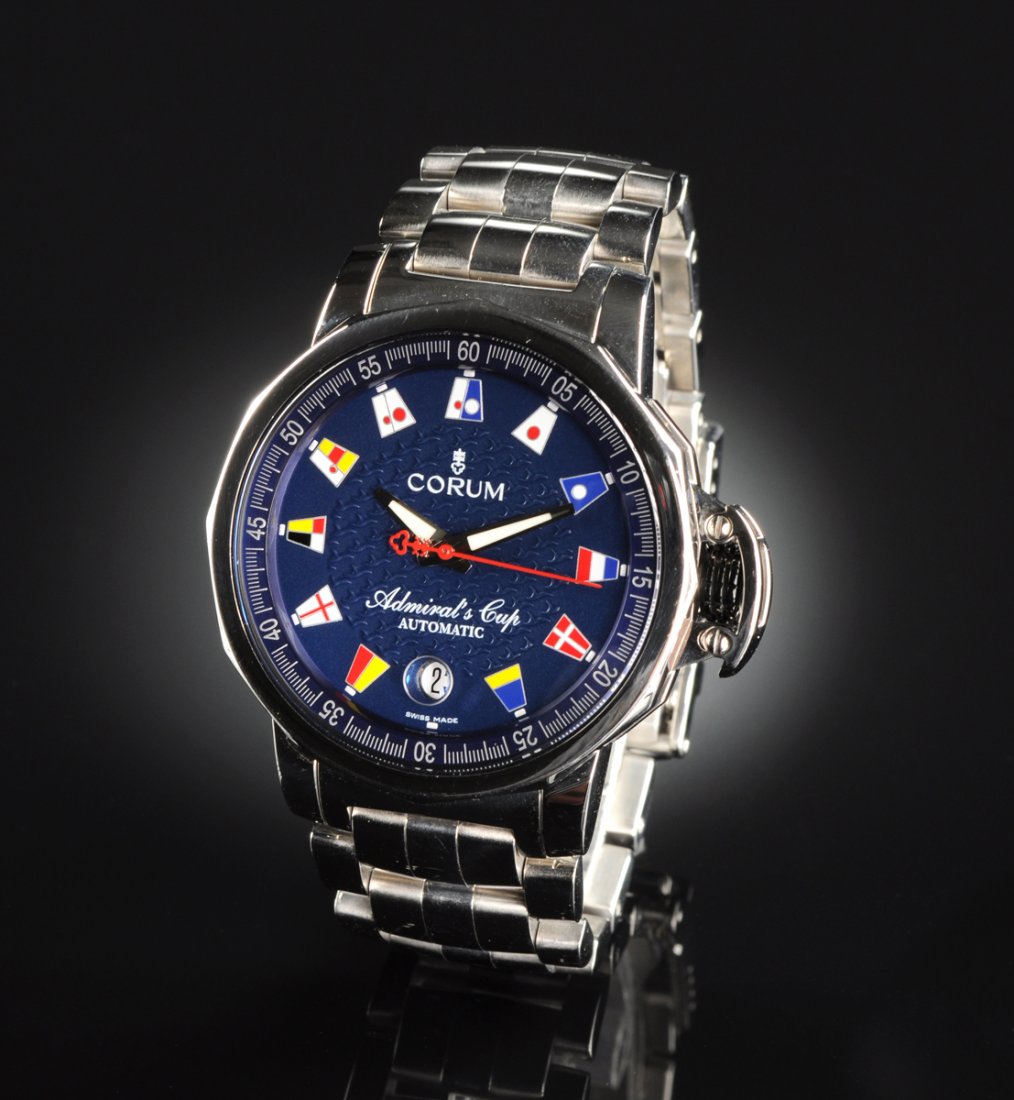 A STAINLESS STEEL CORUM ADMIRALS CUP GENT'S WATCH,: A STAINLESS STEEL CORUM ADMIRALS CUP GENT'S WATCH, Swiss made automatic movement with blue dial and nautical flags at hour markers with calendar at 6 o'clock. Previously owned, no box or papers. Excel