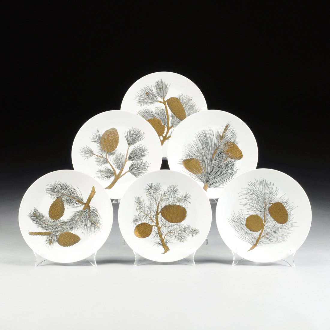 PIERO FORNASETTI (Italian 1913-1988) A SET OF THIRTEEN: PIERO FORNASETTI (Italian 1913-1988) A SET OF THIRTEEN "PIGNE" PATTERN PORCELAIN PLATES, FOR FORNASETTI, MILAN, ITALY, CIRCA 1965, with gold and black transfer printed pine cone decoration, Schonwald
