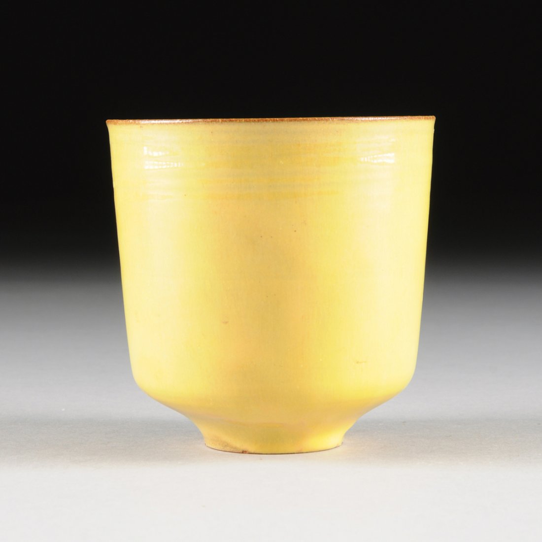 GERTRUD AND OTTO NATZLER (American 1908-1971/1908-2007): GERTRUD AND OTTO NATZLER (American 1908-1971/1908-2007) AN EARTHENWARE TALL VASE WITH YELLOW GLAZE, LOS ANGELES, CALIFORNIA, CIRCA 1960, of slightly tapered cylindrical form and ring foot, with dark b