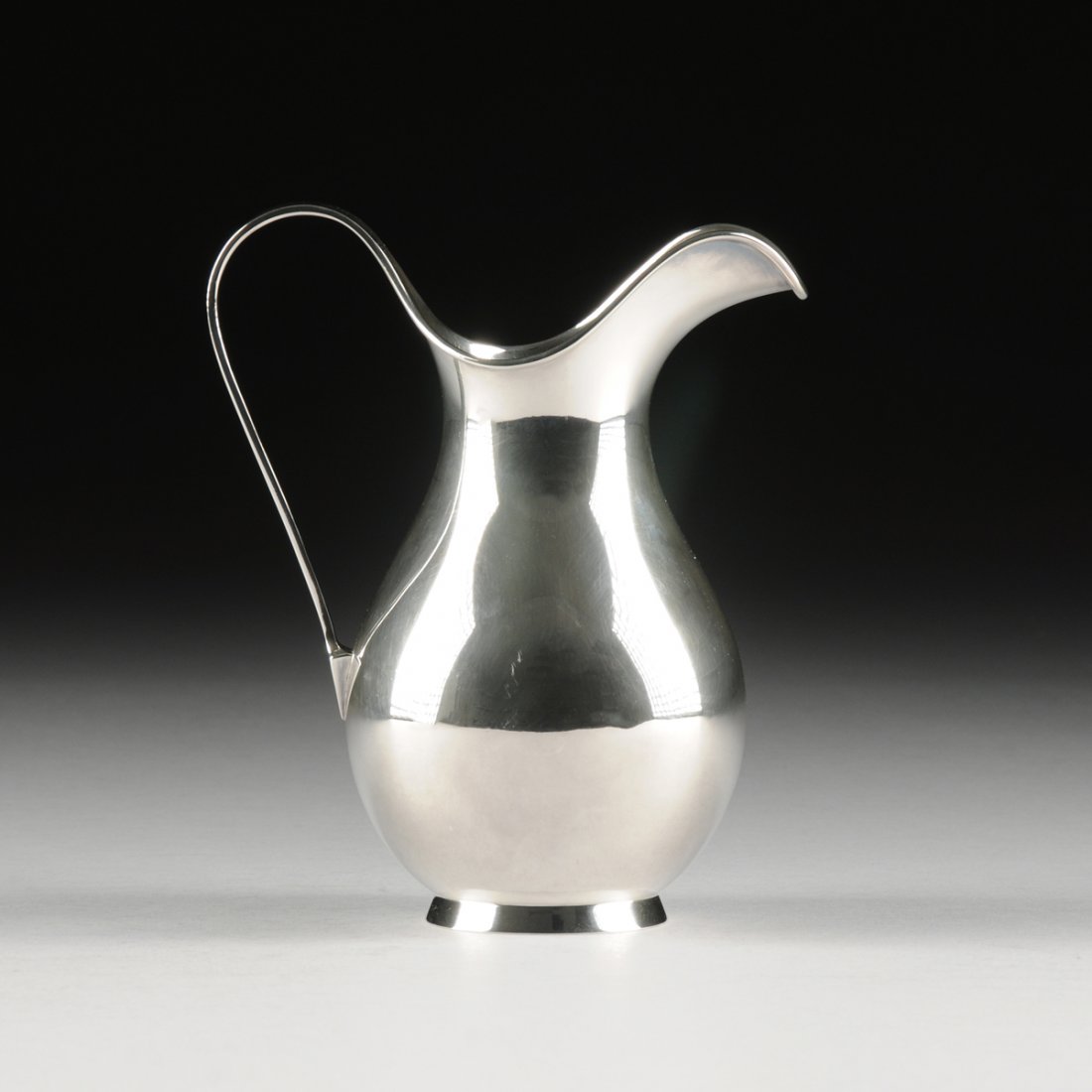 KAY OTTO FISKER (Danish 1893-1965) A STERLING SILVER: KAY OTTO FISKER (Danish 1893-1965) A STERLING SILVER WATER PITCHER, FOR A. MICHELSEN, COPENHAGEN, DENMARK, 1961, of baluster form with everted lip and "C" scroll handle, raised on ring foot, marks: "A