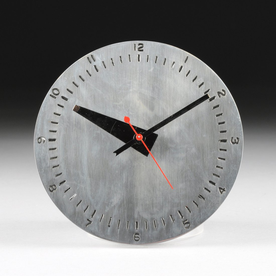 A GEORGE NELSON & ASSOCIATES CHRONOPAK WALL CLOCK,: A GEORGE NELSON & ASSOCIATES CHRONOPAK WALL CLOCK, MODEL 4759, FOR HOWARD MILLER CLOCK COMPANY, ZEELAND, MICHIGAN, DESIGNED 1949, with brushed steel dial, black and red enameled hands, and black numer
