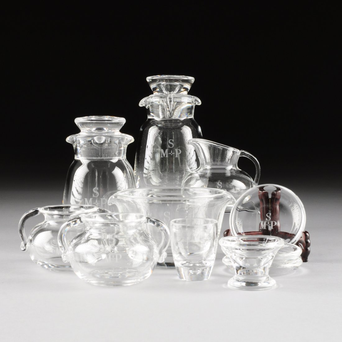 A GROUP OF ELEVEN STEUBEN GLASS WORKS BAR AND SERVING: A GROUP OF ELEVEN STEUBEN GLASS WORKS BAR AND SERVING WARES, CORNING, NEW YORK, CIRCA 1940-1960, all marked "Steuben" (engraved), comprising a pair of "Teardrop" pattern cocktail shakers with covers, 