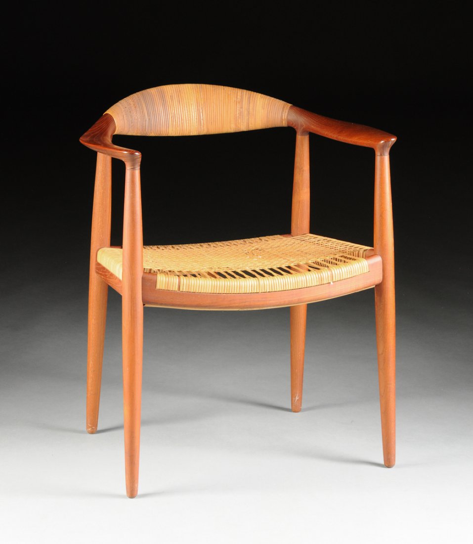 HANS J. WEGNER (Danish 1914-2007) "THE CHAIR," TEAK AND: HANS J. WEGNER (Danish 1914-2007) "THE CHAIR," TEAK AND CANE ARMCHAIR, MODEL JH 501, FOR JOHANNES HANSEN, COPENHAGEN, DENMARK, DESIGNED 1949, PRODUCED 1957, with wrapped cane backrest and woven cane s