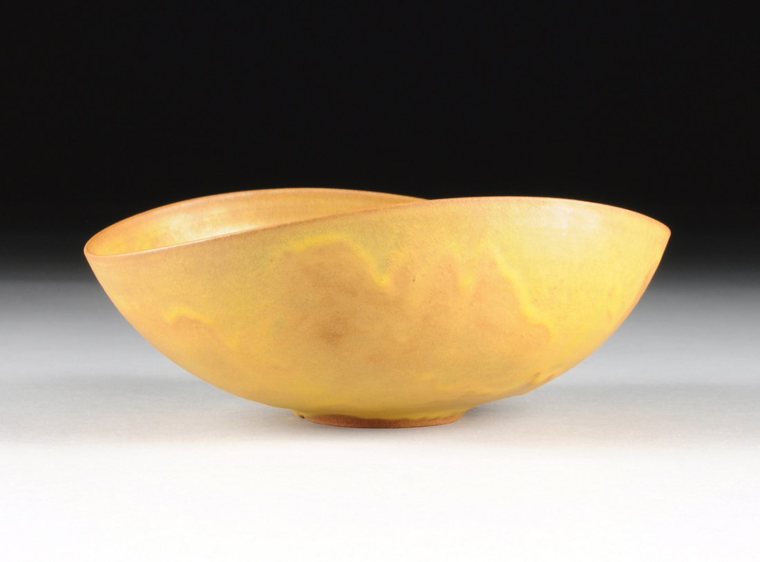 GERTRUD AND OTTO NATZLER (American 1908-1971/1908-2007): GERTRUD AND OTTO NATZLER (American 1908-1971/1908-2007) AN EARTHENWARE FOLDED BOWL WITH MATTE STRIATED SIENNA GLAZE, LOS ANGELES, CALIFORNIA, CIRCA 1955, of modified tall form with ring foot, the glaz