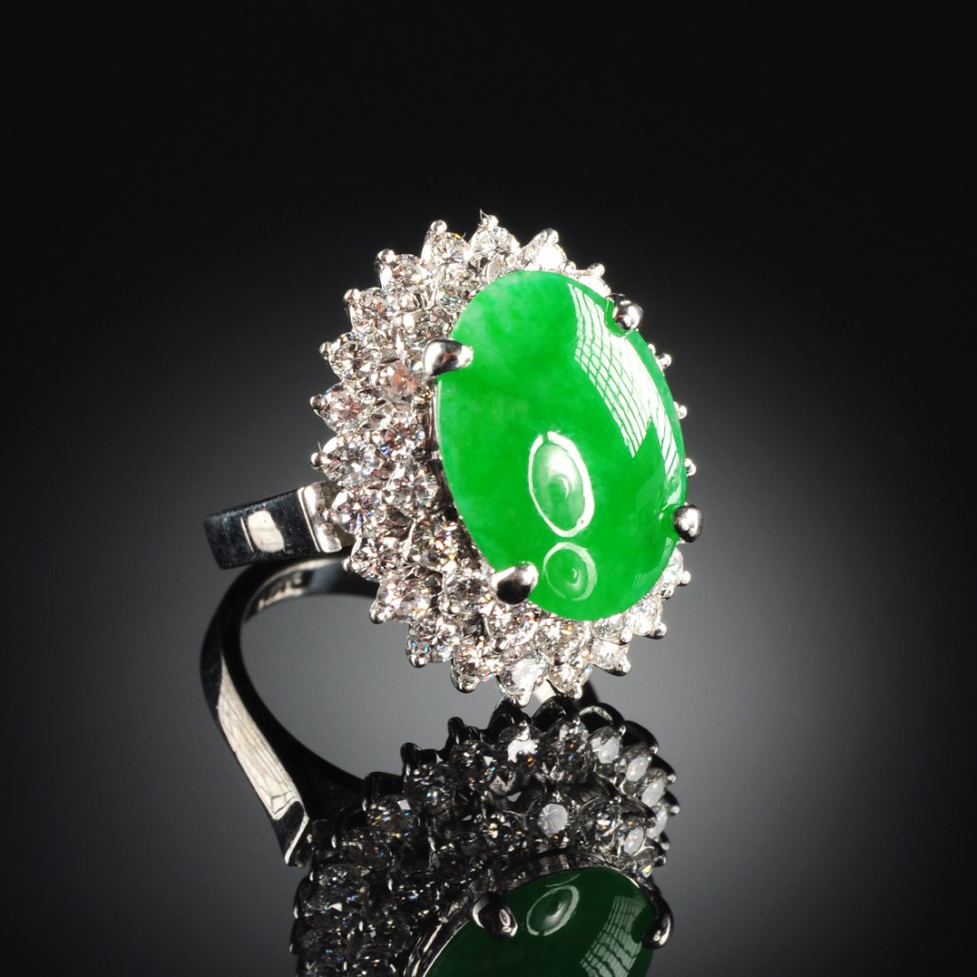 AN 18K WHITE GOLD, CHINESE 'A' JADEITE JADE, AND: AN 18K WHITE GOLD, CHINESE 'A' JADEITE JADE, AND DIAMOND LADY'S RING, with natural, type 'A' jadeite jade oval cabochon measuring approximately ~ 10.17 x 14.00 x 3.4 millimeters, fine green color, f