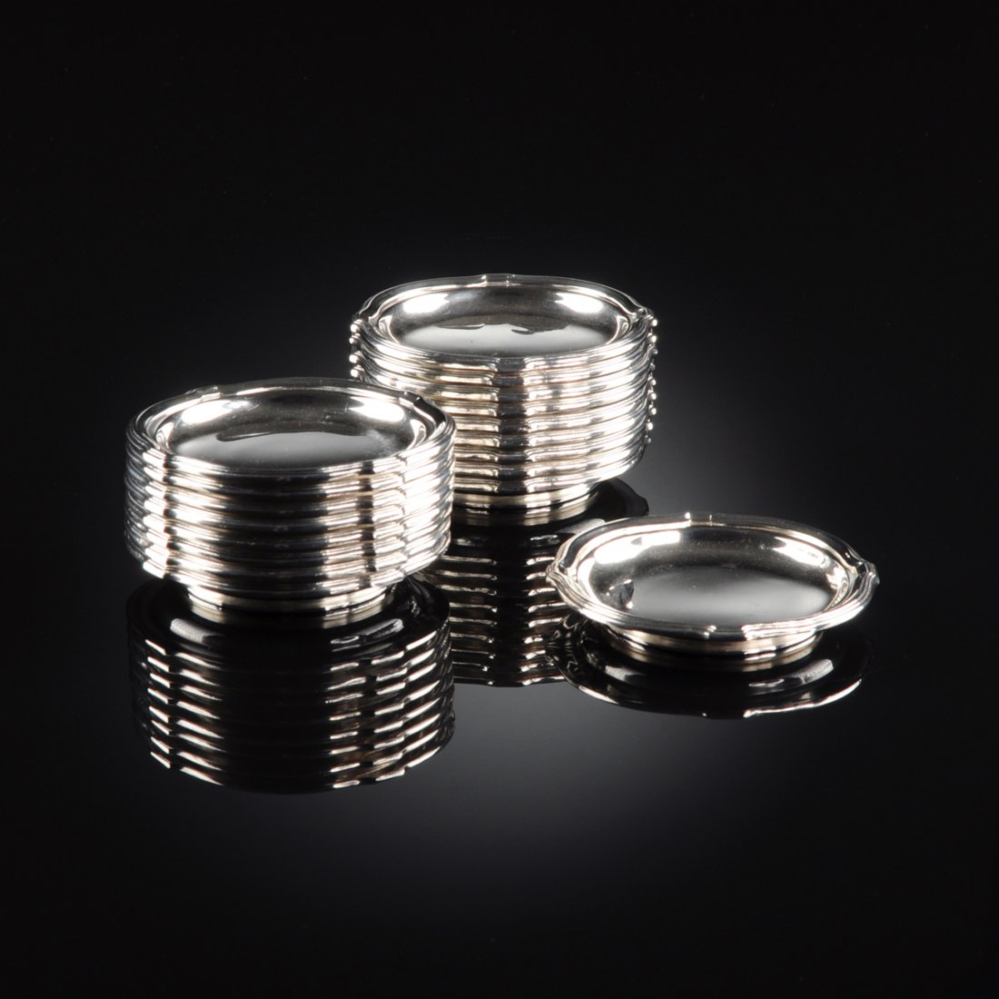 A SET OF EIGHTEEN GUSTAVE KELLER 950 STANDARD SILVER: A SET OF EIGHTEEN GUSTAVE KELLER 950 STANDARD SILVER NUT DISHES, PARIS, FRANCE, CIRCA 1900, of bracketed circular form raised on ring foot, marked to the bottom (G. KELLER, PARIS, MADE IN FRANCE, Merc