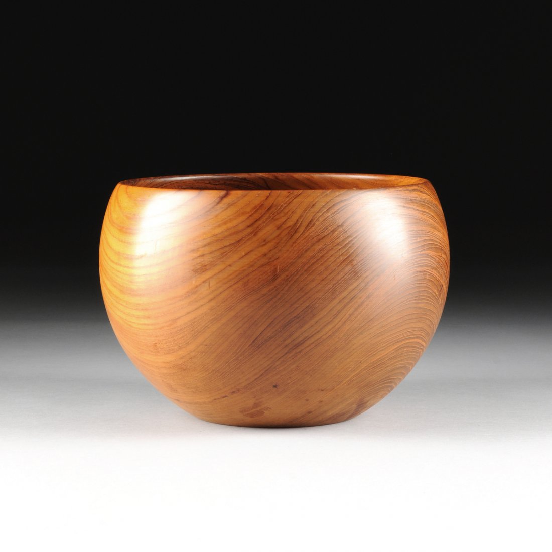 KAY BOJESEN (Danish 1886-1958) A CARVED TEAK SALAD: KAY BOJESEN (Danish 1886-1958) A CARVED TEAK SALAD BOWL, STAMPED, CIRCA 1955, the tapering circular body ending on a flat base, reversing to an impressed stamp, "KAY BOJESEN / COPYRIGHT / SWEDEN." Hei