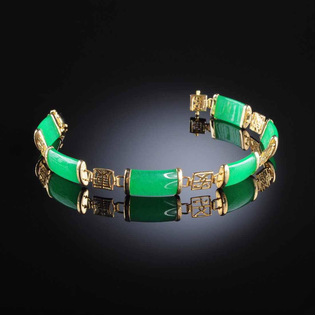 A CHINESE 14KT GOLD AND APPLE GREEN JADEITE BRACELET, (1 of 7)