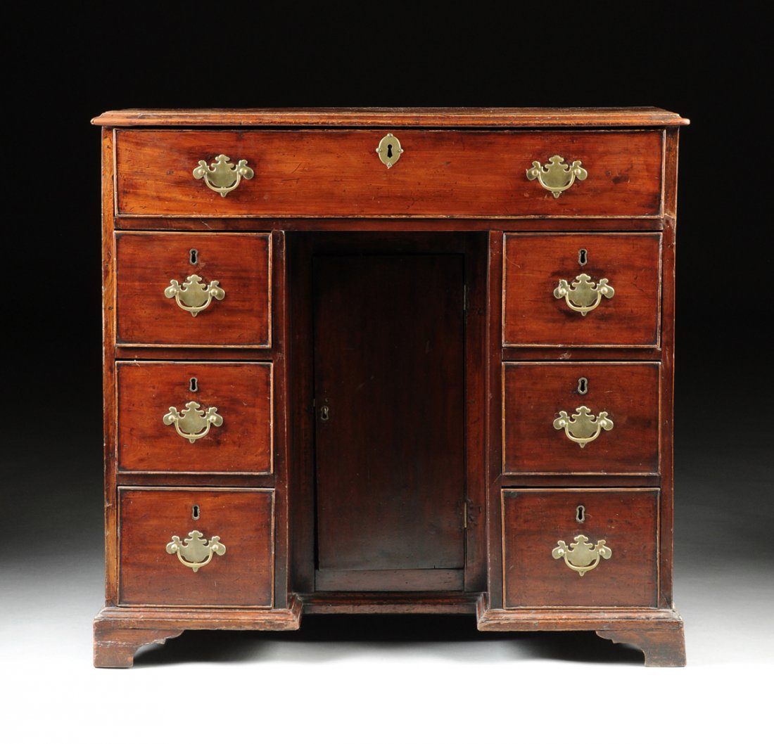A GEORGE III MAHOGANY KNEEHOLE DESK, CIRCA 1775,: A GEORGE III MAHOGANY KNEEHOLE DESK, CIRCA 1775, in the manner of Thomas Chippendale (English 1718-1779), the rectangular molded top over a long drawer and pair of three drawer pedestals enclosing a s
