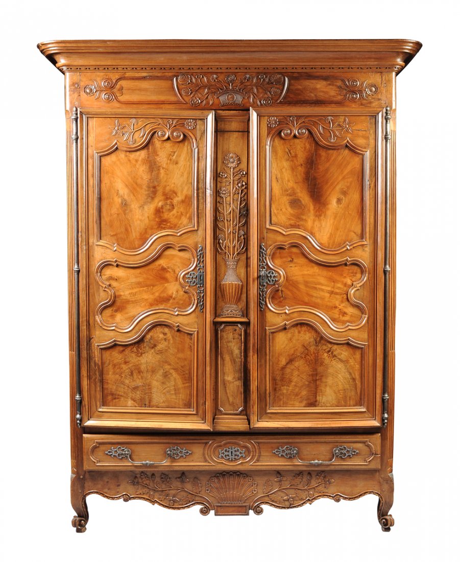 A MASSIVE CROSSBANDED AND HIGHLY FIGURED WALNUT: A MASSIVE CROSSBANDED AND HIGHLY FIGURED WALNUT ARMOIRE, NORMANDY, 18TH CENTURY, imposing in both size and proportion, the upper cupboard with a rounded rectangular top, stepped by an ogee and cove mo