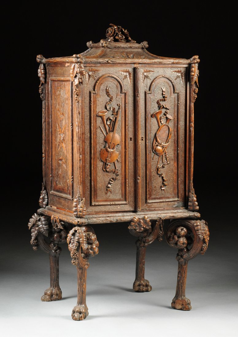 AN UNUSUAL CONTINENTAL CARVED WALNUT MUSIC CABINET, (1 of 10)