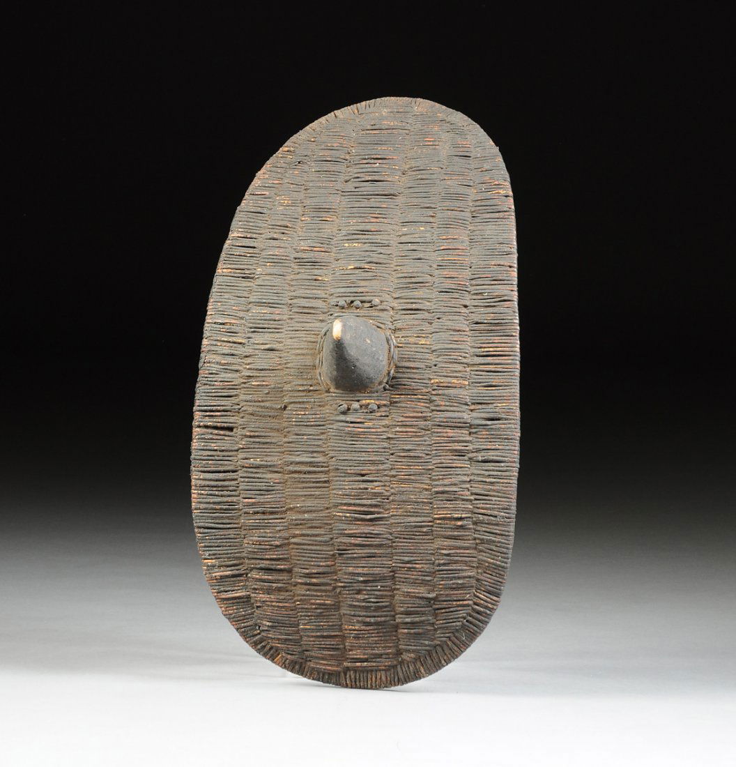 A VINTAGE AFRICAN TRIBAL BLACK PAINTED WICKER SHIELD, (1 of 6)