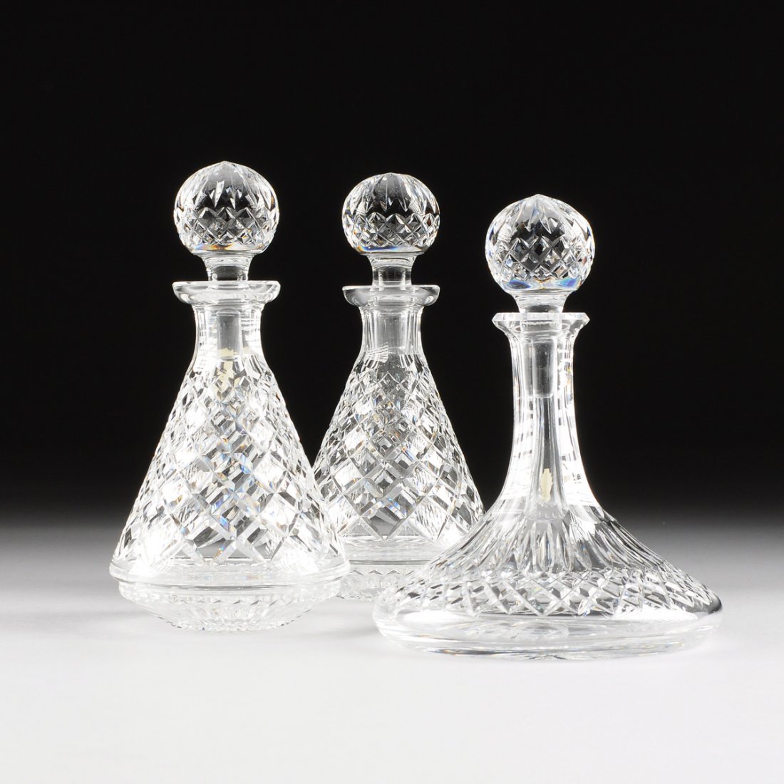 A SET OF THREE WATERFORD CLEAR CRYSTAL DECANTERS, (1 of 10)