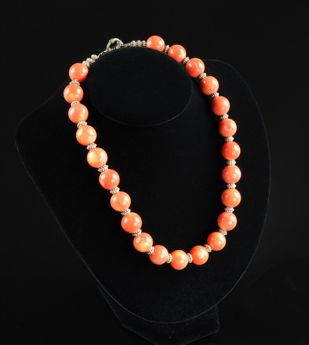 A SILVER GILT AND PINK CORAL LADY'S NECKLACE AND: A SILVER GILT AND PINK CORAL LADY'S NECKLACE AND EARRINGS, the necklace comprising twenty-three round coral beads measuring approximately 22-24 millimeters alternating silver gilt spacers, the dangle 