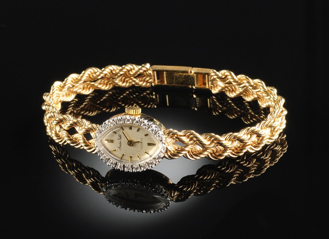 A 14K YELLOW GOLD AND DIAMOND LADY'S WATCH,: A 14K YELLOW GOLD AND DIAMOND LADY'S WATCH, with double four millimeter rope chain bracelet, with the name Andre Pailet on dial, and with Swiss ETA quartz movement. Diamond bezel approximately .20 Cts