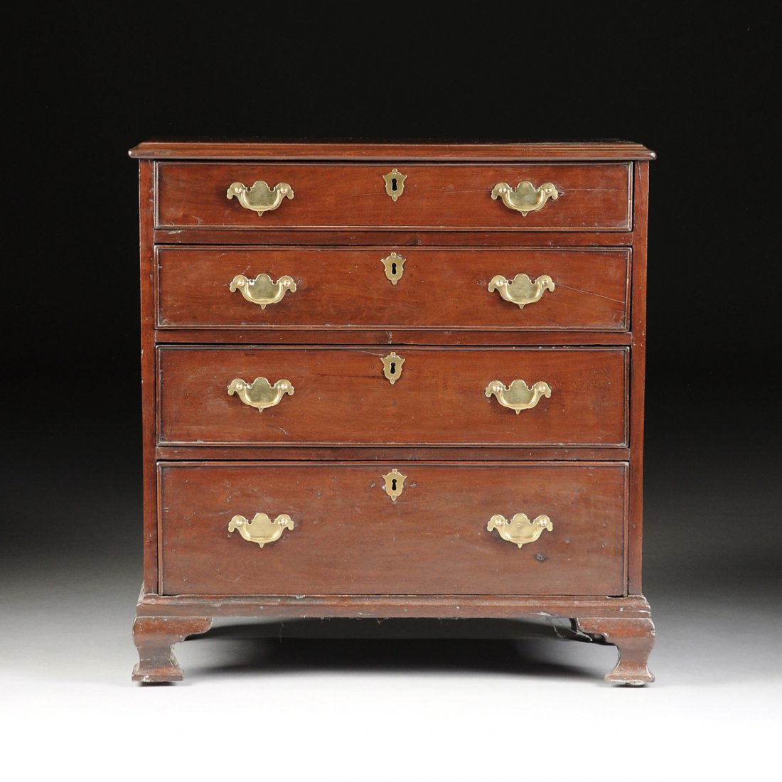 AN AMERICAN CHIPPENDALE CARVED MAHOGANY CHEST OF: AN AMERICAN CHIPPENDALE CARVED MAHOGANY CHEST OF DRAWERS, POSSIBLY PENNSYLVANIA, 18TH CENTURY, the rectangular top within a molded edge above four recessed panel graduated drawers, centering "later" p
