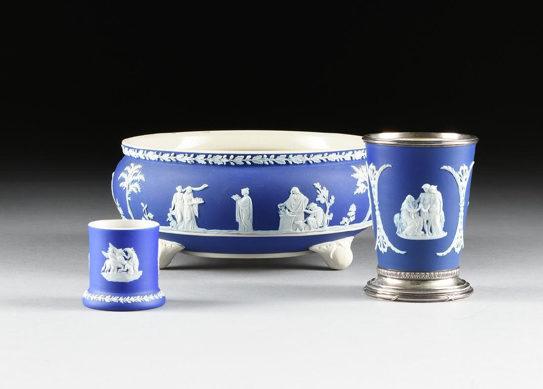 A GROUP OF THREE WEDGWOOD DARK BLUE DIP JASPERWARE: A GROUP OF THREE WEDGWOOD DARK BLUE DIP JASPERWARE BAS-RELIEF WARES, ETRURIA, STAFFORDSHIRE, ENGLAND, LATE 19TH CENTURY, comprising a small cup with sprigged cameo decoration of "Bellerophon watering