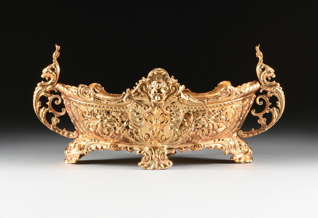 A GOLD PAINTED CAST IRON JARDINIERE, CIRCA 1890-1900,: A GOLD PAINTED CAST IRON JARDINIERE, CIRCA 1890-1900, of shaped oval form with reticulated sides in the Baroque Revival style, decorated with female busts in a shell form cartouche flanked by cast flo