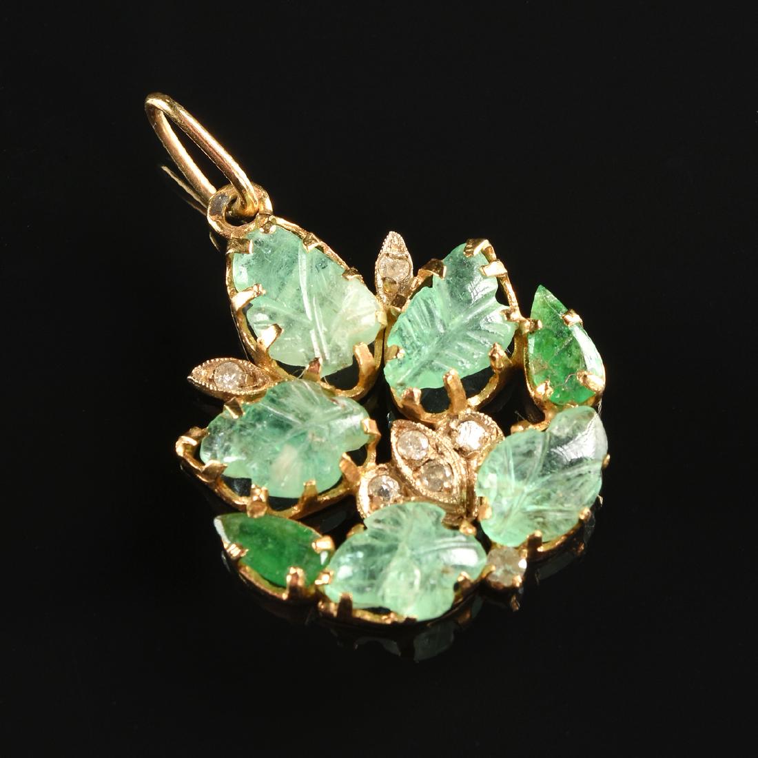 A YELLOW GOLD BREEN BERYL, EMERALD, AND DIAMOND LADY'S: A YELLOW GOLD BREEN BERYL, EMERALD, AND DIAMOND LADY'S PENDANT, unstamped measuring 1" x 1 1/4" and set with approximately 8 x 6 millimeter green beryl leaves, two emeralds measuring approximately 4 x