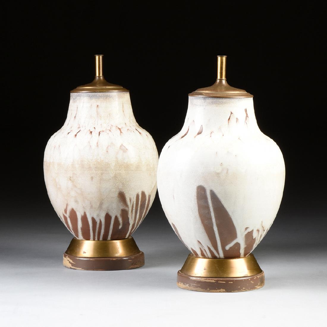A PAIR OF TERRA COTTA WHITE GLAZED LAMPS, MID 20TH: A PAIR OF TERRA COTTA WHITE GLAZED LAMPS, MID 20TH CENTURY, each round tapered with short neck over graceful shoulder, the white slip glaze revealing the natural terra cotta below, on circular brass b