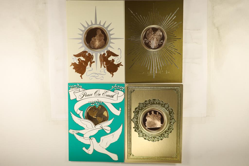 4 FRANKLIN MINT HOLIDAY CARDS WITH 1 1/2": BRONZE TOKENS THAT ARE BRILLIANT UNC SEALED IN PLASTIC WITHIN THE CARDS