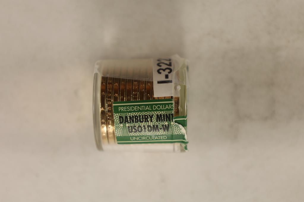 ROLL OF 12 BRILLIANT UNC PRESIDENTIAL DOLLARS: JAMES POLK IN DANBURY MINT ROLL. LID IS CRACKED