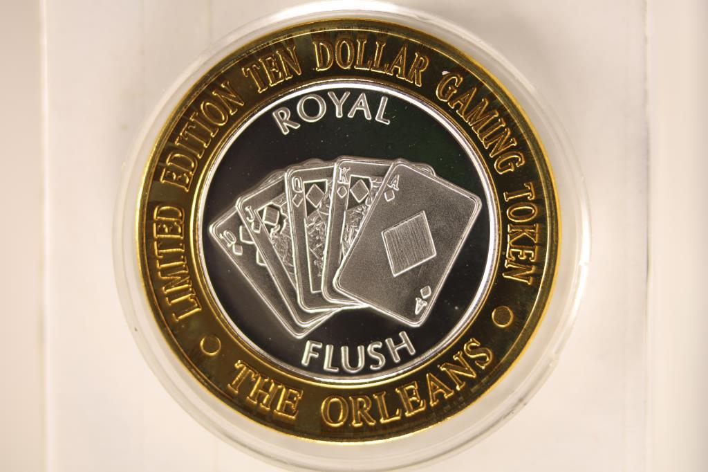 $10 CASINO SILVER UNC GAMING TOKEN. "THE ORLEANS,: LAS VEGAS NEVADA" ON THE OBVERSE AND "ROYAL FLUSH" ON THE REVERSE. LIMITED EDITION IN HARD PLASTIC CAPSULE