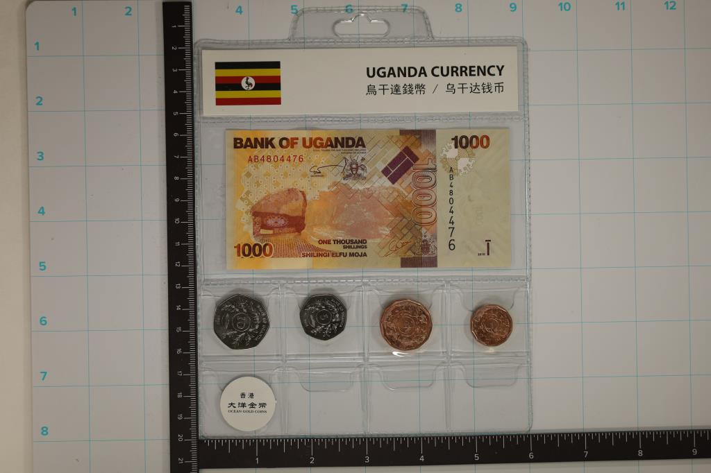 UGANADA CURRENCY & COIN SET FEATURES: 2010-1000: SHILLINGS CRISP UNC BILL AND 4-1987 BRILLIANT UNC COINS IN PLASTIC SLEEVE.