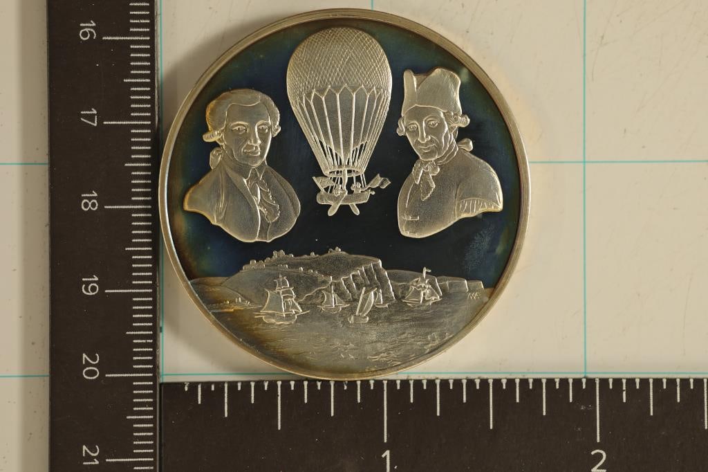 1.31 TROY OZ. PF STERLING SILVER HOT AIR BALLOON: THEMED ROUND: JEAN PIERRE BLANCHARD 1753-1809 AND DOCTOR JOHN JEFFERIES 1744-1819. 1ST CROSSING OF THE SEA BY AIR, 7TH JANUARY 1785. OFFICIAL ROYAL AIRFORCE MUSEUM MEDAL. IN HARD PLASTIC CAPSULE