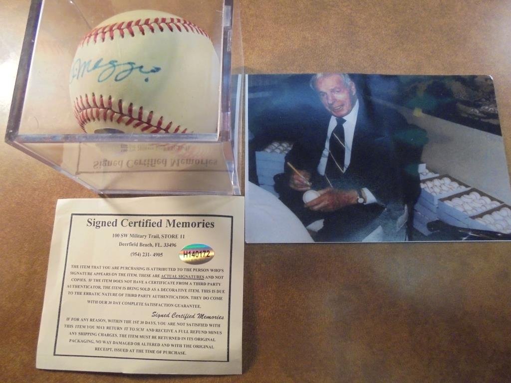 JOE DIMAGGIO SIGNED BASEBALL WITH PIC OF HIM SIGNING: SIGNING BALLS. BIDALOT DOES NOT GUARANTEE AUTHENTICITY