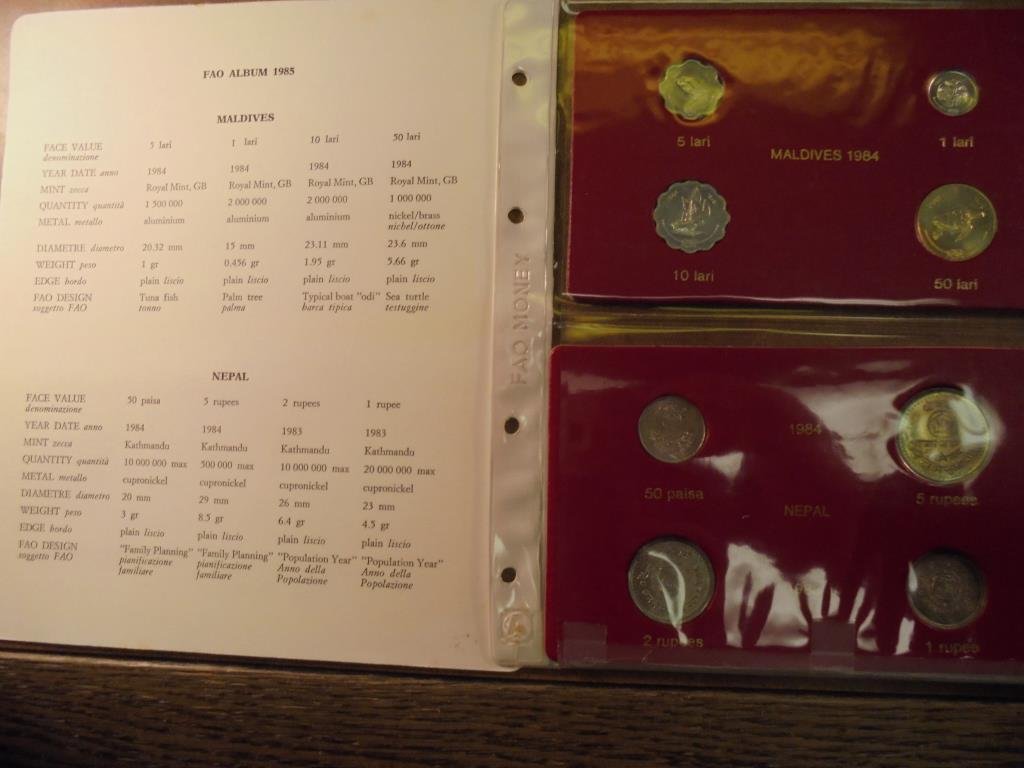 1985 FAO ALBUM PAGE WITH 4-1984 MALDIVES, 2-1983 AND: AND 1984 NEPAL COINS