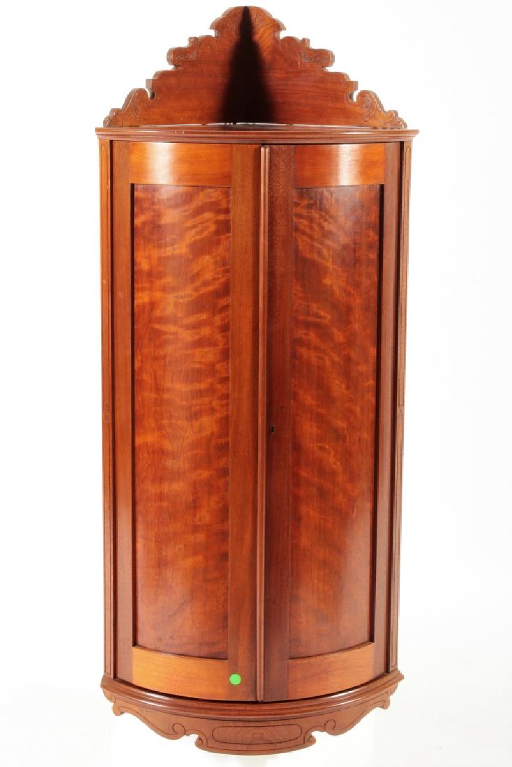 Victorian Corner Cabinet, Flame Mahogany, 19th C.: A Victorian Era Corner Cabinet, late 19th C., flame mahogany with cornice atop and rounded front. (JOMI3210)(WK) Dimensions: 48 H x 22 W x 19 D Provenance: From the Randolph Collection, Philadelphia, 