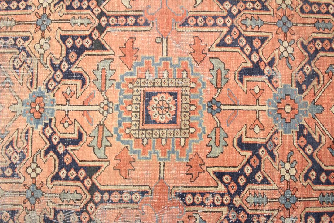 Middle Eastern "Heriz" Rug: Red ground, blue border. (GSHE3717)(JM) Dimensions: 8' 4" x 10' 10" Provenance: From the Collection of prominent Author, Gail Sheehy whose best known work 'Passages' was named one of the ten most infl