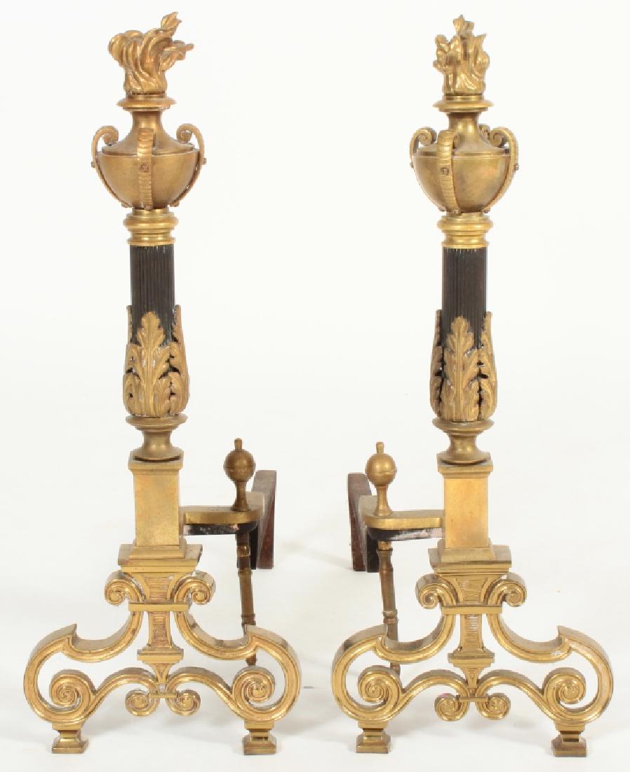 Pair of French Empire Style Torchiere Andirons: Pair of French Empire Style Torchiere Andirons, patinated and bright brass. (DDIS3010/2)(TC) Dimensions: 26" H, support extends 21" Provenance: From a Gustav Stickley home in Colonial Heights, Yonkers