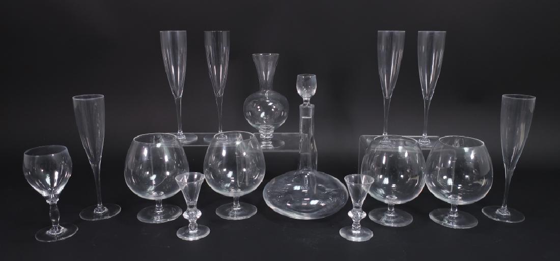 14 Crystal Items: Steuben Snifters Baccarat Kosta: Lot of 14 Crystal Items: Steuben: four large brandy snifters,two aperitif glasses. Baccarat: six champagne flutes, a wine glass and a vase. Kosta: decanter w/ stopper. (QWET3409/15)(AC) Dimensions: Sn