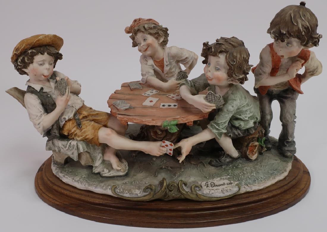 Giuseppe Armani Figurine: The Cheaters Cardplayers: Giuseppe Armani Figurine: The Cheaters #3280C. Four Boys Playing Cards. Old Fortunoff's label underneath with $399. (DDIS3050)(TC) Dimensions: 10" H & 17.5" W x Provenance: From a Gustav Stickley home