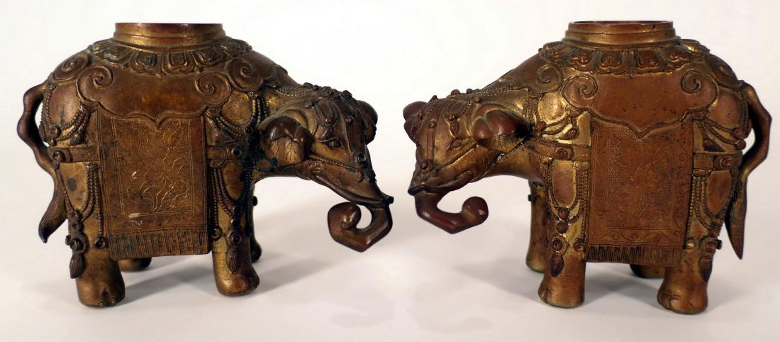 Pr. 19th c. Chinese Bronze Elephant-Form Censers: A pair of 19th century finely cast elephant-form bronze censers, lacking their original pierced elements, (CMCL8000/2) (TC) Dimensions: each 4.75" H x 6" L