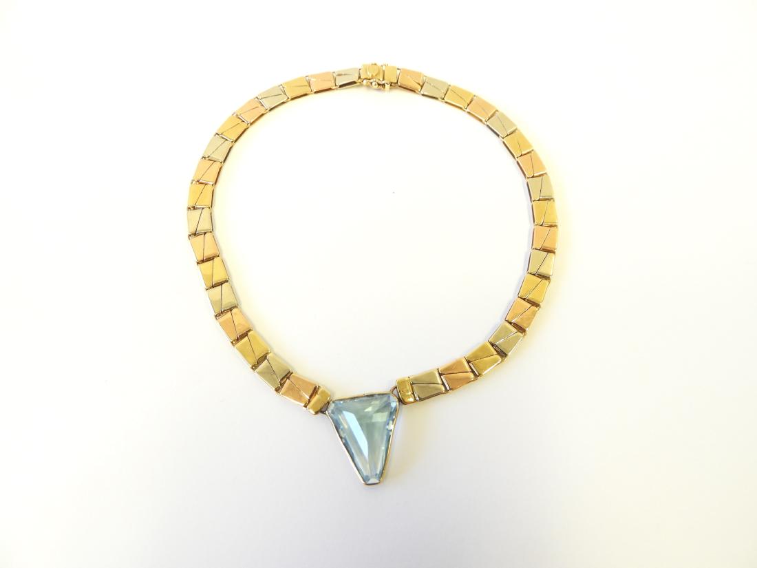 18k Rose, Yellow, & White Gold with Topaz Necklace: Designed by Chimento, Italy. Featuring a line of rectangular polished rose, yellow, and white gold links centering a calf head shaped blue topaz measuring approximately 20 x 16.5 x 8 mm and weighing a