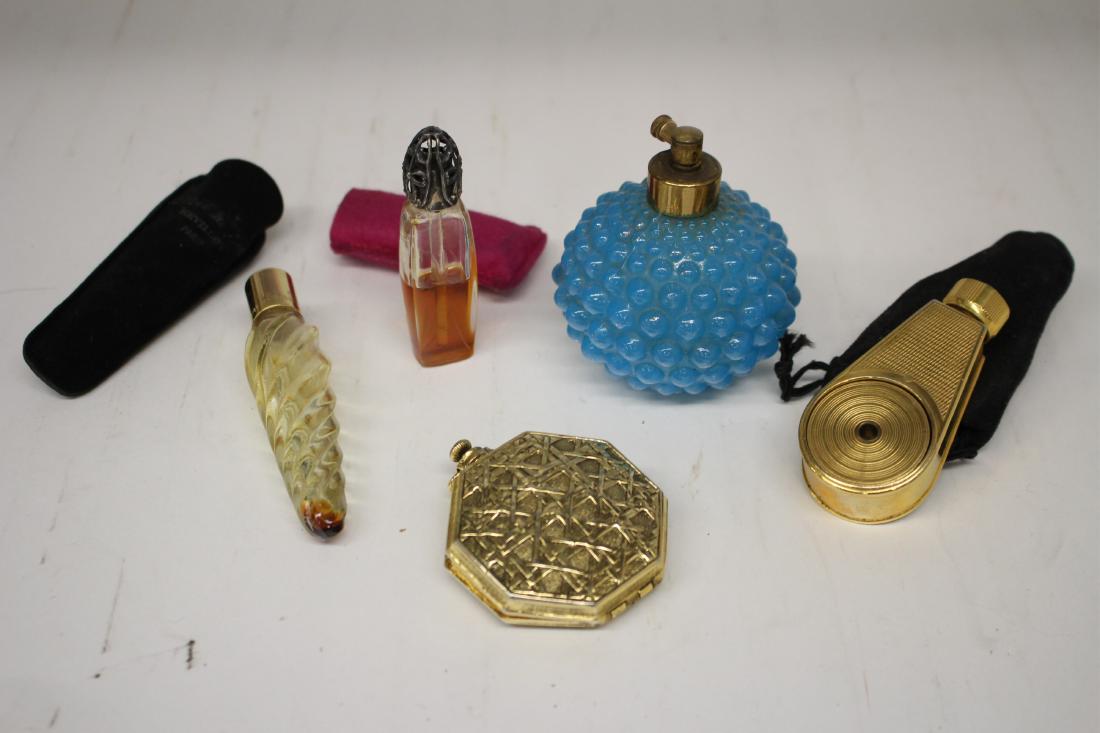 Four Perfumers, One Compact: Three made in France; one round knobby in blue. One perfumer with side bellows style; one silver plate reticulated top with etched flowers on glass. Three in cases. one dried. Compact in octagonal for
