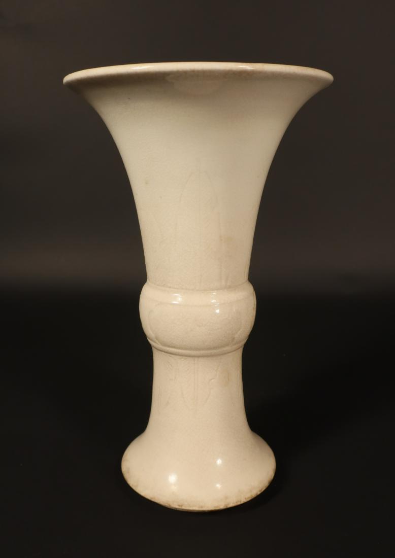 Chinese White Porcelain Gu (Beaker Form) Vase: Leaf incised design and crackle glaze, label on base reads "K'ang Hsi & Warren E. Cox Collection" Dimensions: 9" H x 5" Dia. (GMAL35-327) (WT)