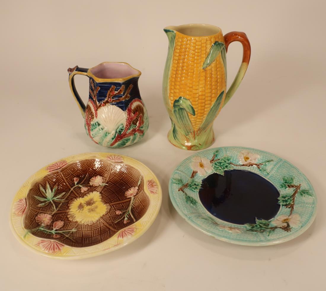 Majolica Plates, Pitcher; Staffordshire Pitcher: Majolica seashell and coral pitcher, hexagonal opening; Two plates: Floral branching border with deep blue center and a second plate with lobed interior with floral branch over geometric underpattern.