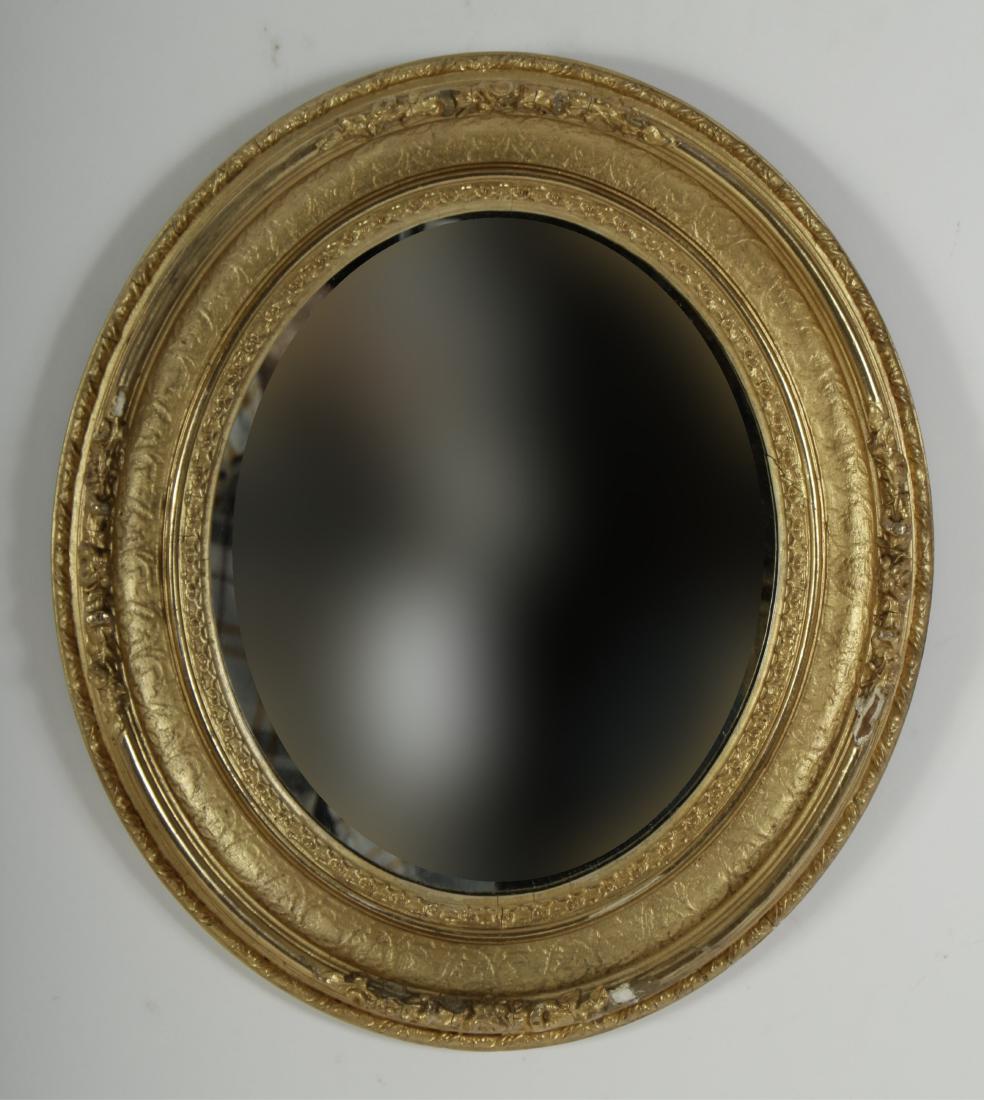 Oval Gilt Framed Mirror: DIMENSIONS: 16 1/2" H x 14 1/2" W We encourage all bidders to obtain shipping quotes before placing bids. Property from a Westchester County, New York estate (EPEN45-29) (WT)