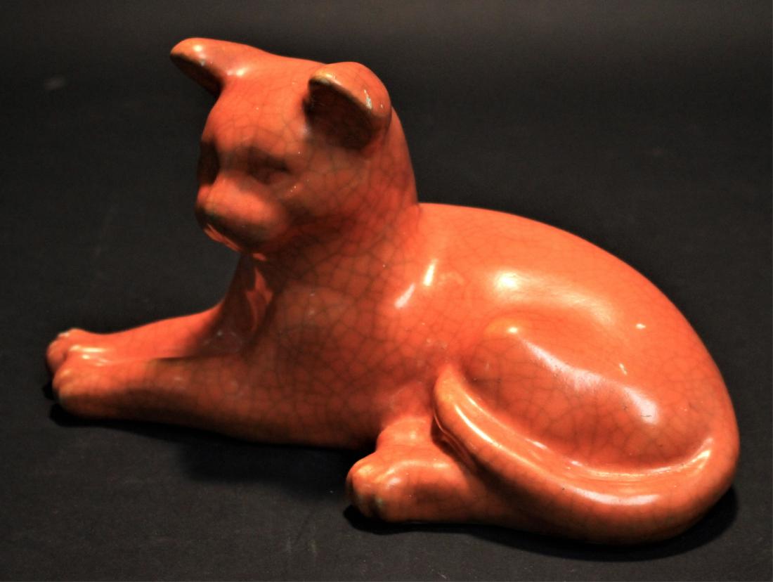 Orange Pottery Cat: Reclining, with crackle glaze DIMENSIONS: 6" H x 10 1/2" L We encourage all bidders to obtain shipping quotes before placing bids. Property from the Collection of Arthur & Lillian Weiss, Little Deer I