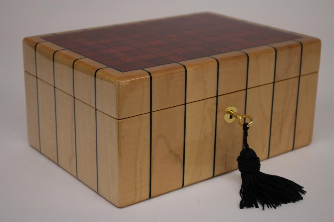 Modern Lacquer Finish Lidded Jewelry Box: by Wild Wood. Removable interior tray. Key lock. Red fabric interior. Red finish random pattern graining squares to top. DIMENSIONS: 5"H x 10.5W x 7.5 We encourage all bidders to obtain shipping quot