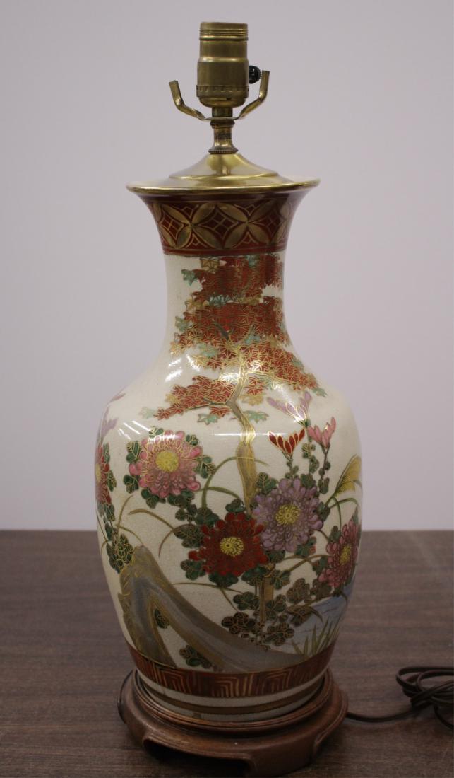 Japanese Ceramic Vase Form Lamp: Floral and waterside motif. Marked on base Toyo/Japan. Wood base. DIMENSIONS: With base: 16"H We encourage all bidders to obtain shipping quotes before placing bids. (BMIL4498) (JP)