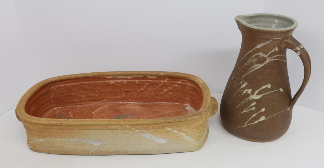 Two Functional Art Pottery Forms By Crowe: Kevin Crowe. Pitcher w/ glazed interior, matte glaze exterior w/ splash and stroke design. Rectangular baking or serving dish, two cast in handles, reddish interior w/ "spear" incised design. Potters 